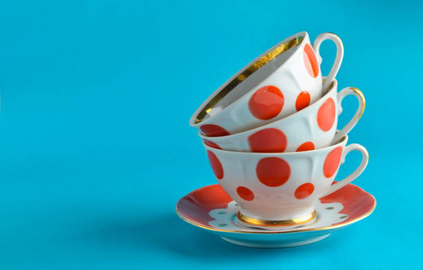 istock stack of antique ceramic cups on a saucer on a blue background, copy space 1096765342