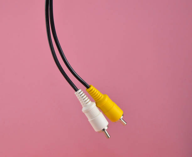 RCA yellow white audio/video cable on pink background.