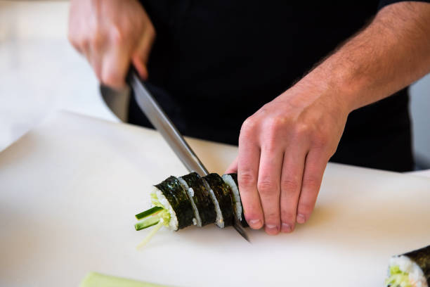 istock Chef cutting sushi in the bar 1096769862
