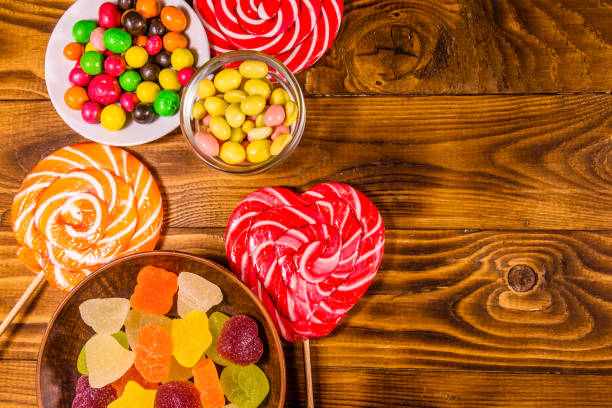 istock Different sweet candies on a wooden table. Top view 1096780866