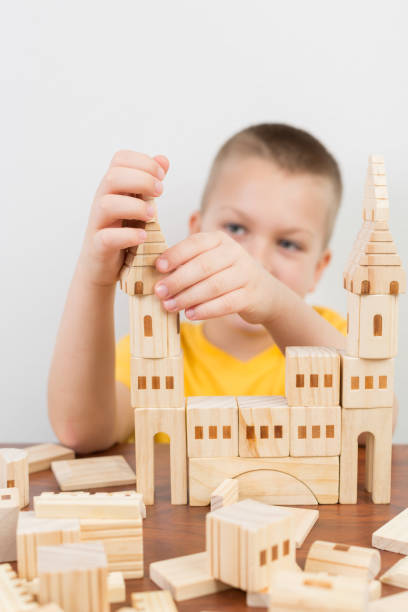 istock Young boy builiding castle using wooden blocks 1096787780