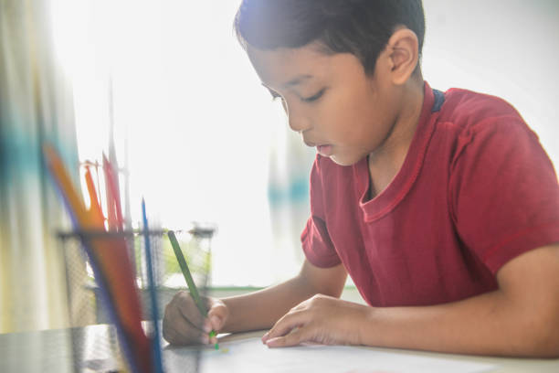istock An Asian 9 year old boy doing homework 1096789594