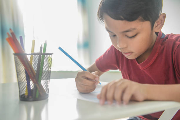 istock An Asian 9 year old boy doing homework 1096789602