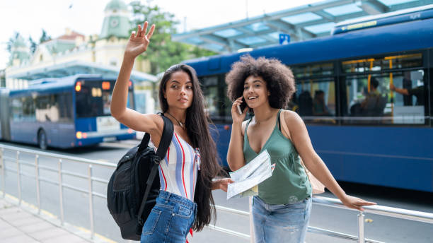 istock Girlfriends standing on station and looking for taxi 1096789736