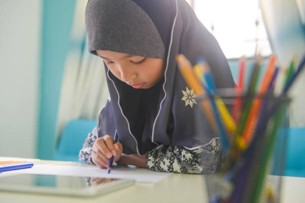 istock Asian girl doing homework with digital tablet at home 1096792732