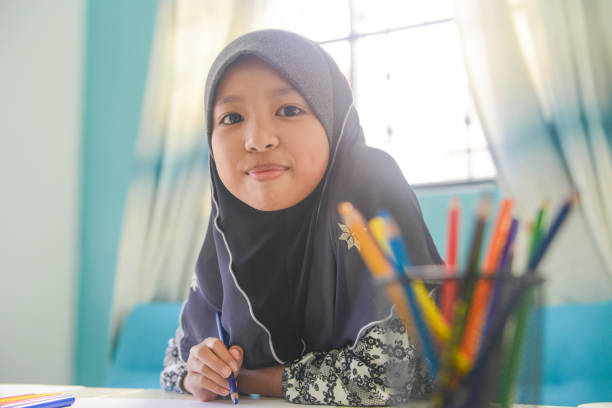 istock Asian girl doing homework at home 1096792786