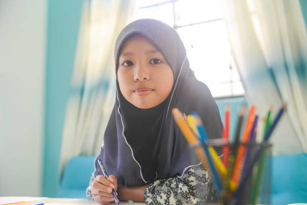 istock Asian girl doing homework at home 1096792852