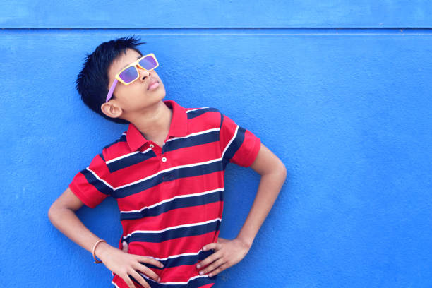 Attractive Indian young boy model posing to camera with glasses