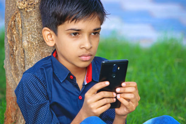 593 Indian Boy Playing With A Mobile Phone Stock Photos, Pictures &  Royalty-Free Images - iStock