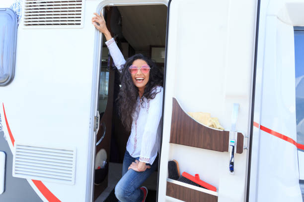 istock Smiling woman standing on camper's door 1096794928