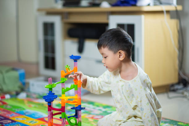 istock cute boy playing with toy at home 1096797504