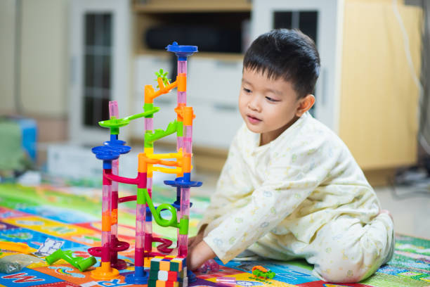 istock cute boy playing with toy at home 1096797518