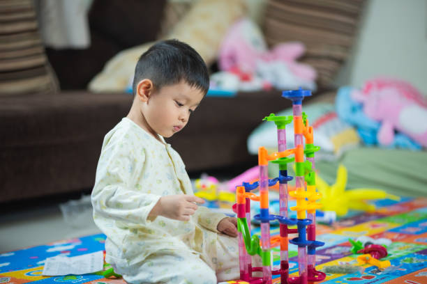 istock cute boy playing with toy at home 1096797560