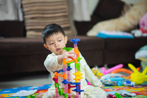istock cute boy playing with toy at home 1096797592