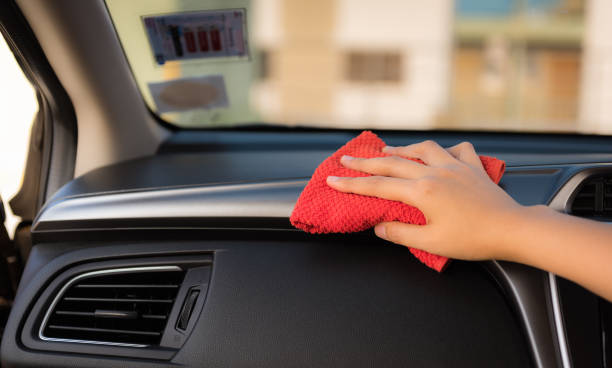 istock Closeup woman hand is washing and cleaning with microfiber at console panel inside a car., Car maintenance service and transportation concept. 1096804416