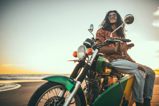 istock Handsome man on a motorcycle at the beach 1096806458