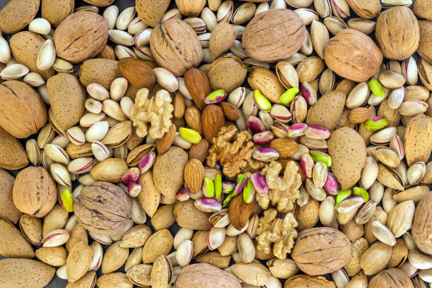 istock Different types of nuts- assorted walnuts, almonds and pistachios. Concept- healthy diet,  full source of vegetable protein in vegetarianism and raw food. Background. 1096807624