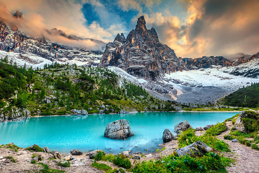 Wonderful hiking, photography and recreation place. Famous lake Sorapis with high snowy mountains at sunset, Dolomites, Italy, Europe