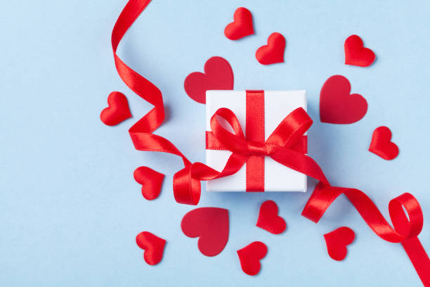 istock Valentine day card or banner. Gift or present box and red hearts on blue background. Flat lay. 1096814638