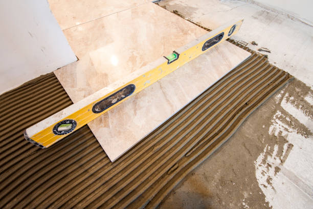 istock Ceramic tiles and tools for tiler. Floor tiles installation. Home improvement, renovation - ceramic tile floor adhesive, mortar, level 1096815226