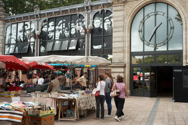 Narbonne Narbonne Market. France. Shop selling books ahead of the market. This indoor market had a variety of fruit, fish, meat, and other stands. It's worth a quick peek, but the real highlight of Narbonne is the old city (a but further down the canal). Narbonne, Occitan: Narbona, Latin: Narbo is a commune in southern France in the Languedoc-Roussillon region. It lies 849 km from Paris in the Aude department, of which it is a sub-prefecture. Once a prosperous port, and a major city in Roman times, it is now located about 15 km from the shores of the Mediterranean Sea. It is marginally the largest commune in Aude, although the prefecture is the slightly smaller commune of Carcassonne."n narbonne stock pictures, royalty-free photos & images