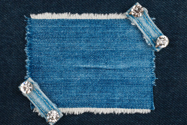 Denim frame with fringe and two belts with rhinestones. Top view