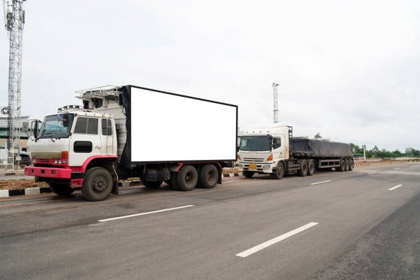 istock container trucks Logistic by Cargo truck on the road .empty white billboard .Blank space for text and images 1096818796