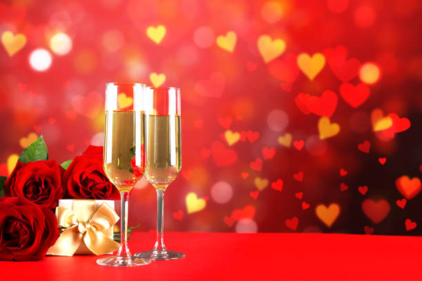 istock Champagne for couple in love in two flutes on table with red tablecloth. 1096825414