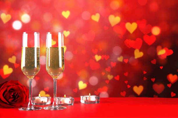 istock Champagne for couple in love in two flutes on table with red tablecloth. 1096825862