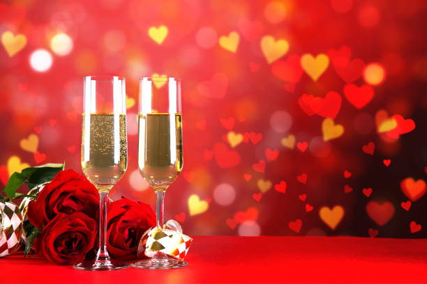 istock Champagne for couple in love in two flutes on table with red tablecloth. 1096825882
