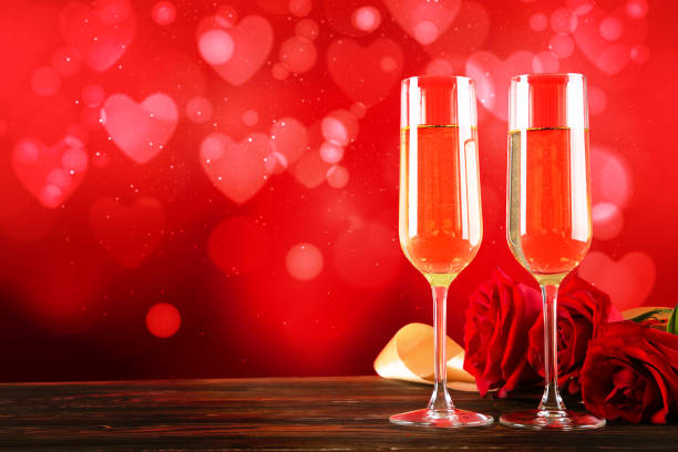 istock Champagne for couple in love in two flutes on table with red tablecloth. 1096826700