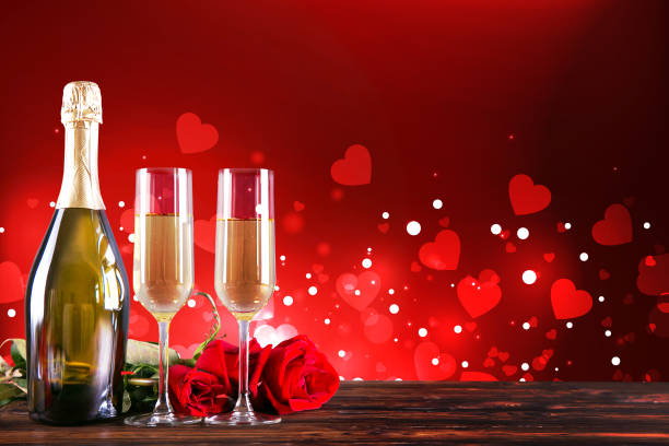 istock Champagne for couple in love in two flutes on table with red tablecloth. 1096827042