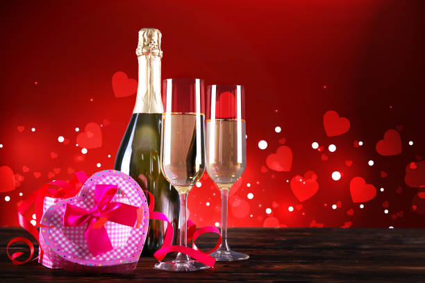 istock Champagne for couple in love in two flutes on table with red tablecloth. 1096828406