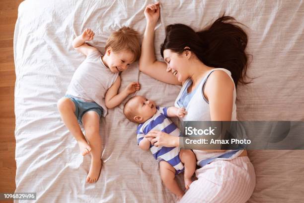 Happy Loving Family Of Mother And Two Sons Young Mom Relaxing And Hugging With Her Children At Evening Stock Photo - Download Image Now - iStock Happy Loving Family Of Mother And Two Sons Young Mom Relaxing And Hugging With Her Children At Evening Stock Photo - Download Image Now - iStock