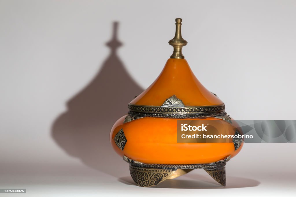 pot for traditional Moroccan spices or spices pot for traditional Moroccan spices or spices, orange with metallic decorations Container Stock Photo