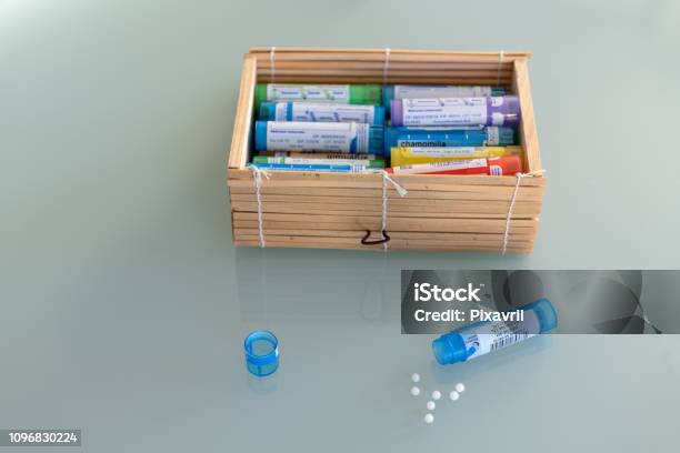 Homeopathic Globules Scattered Around With Their Colored Containers In The Shape Of Tube Stock Photo - Download Image Now