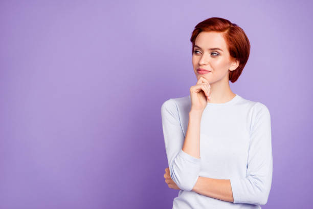 Close up portrait of beautiful cute pretty charming she her girl Close up portrait of beautiful cute pretty charming she her girl wondering gladly looking to empty space wearing white casual sweater on violet background deep pick stock pictures, royalty-free photos & images
