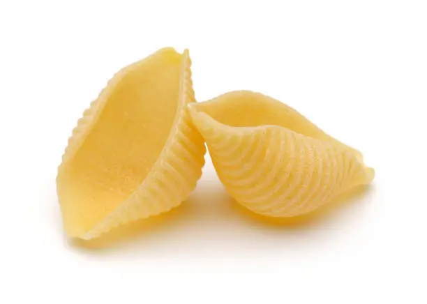 Photo of Conchiglie rigate pasta on white background