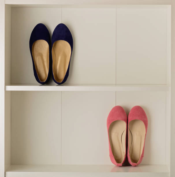 Women's shoes (ballet shoes) in the white wardrobe. Selective focus.