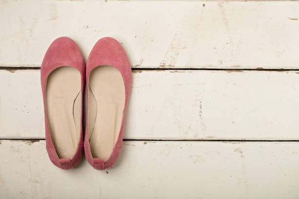 istock Pink women's shoes (ballerinas) on wooden background. 1096837802