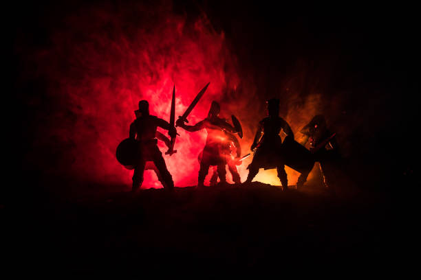 istock Medieval battle scene. Silhouettes of figures as separate objects, fight between warriors on dark toned foggy background. Night scene. 1096840834
