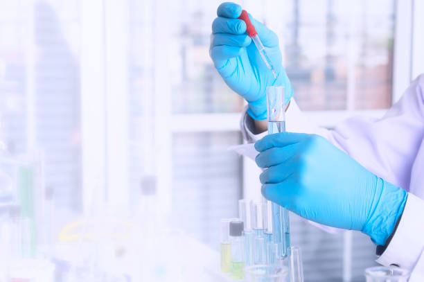 istock Scientist holding sampling oil or chemical liquid in flask with lab glassware in laboratory background. 1096842000