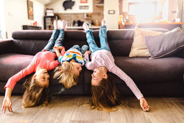 istock Playful kids having fun on sofa in the living room. 1096845018