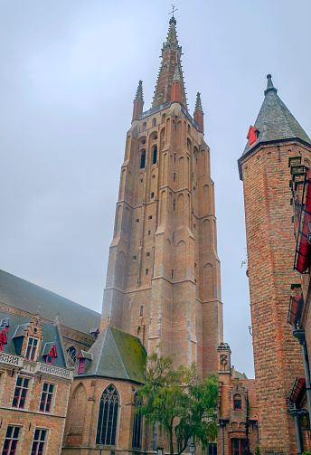 Cathedral of Bruges in Belgium with its medieval style facades on a cloudy day.