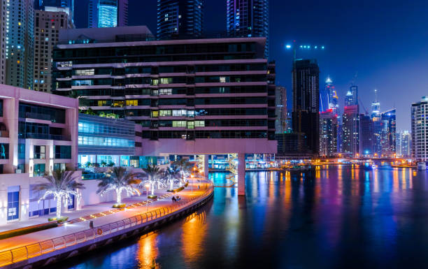 istock Illuminated Buildings By River In City At Night 1096848256