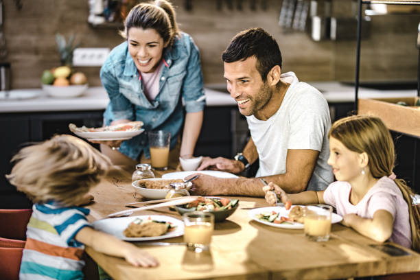 istock Happy family communicating during lunch in dining room. 1096848782
