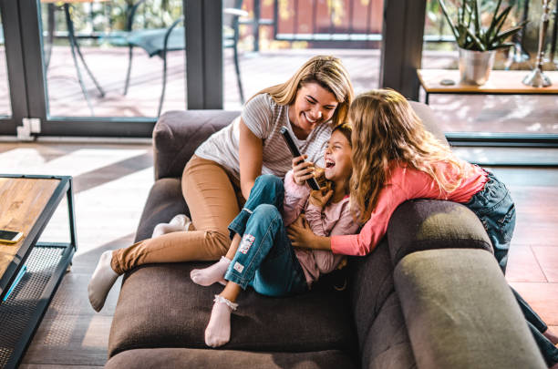 istock Happy single mother having fun with her daughters at home. 1096849696