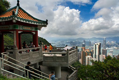 Tourists enjoy the views from the Sky Terrace on the  from Victoria Peak Tower. Hong Kong, China, SAR