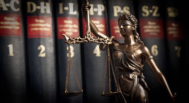 istock Statue of justice on books background 1096860276