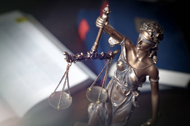 istock Statue of justice on books background 1096860308
